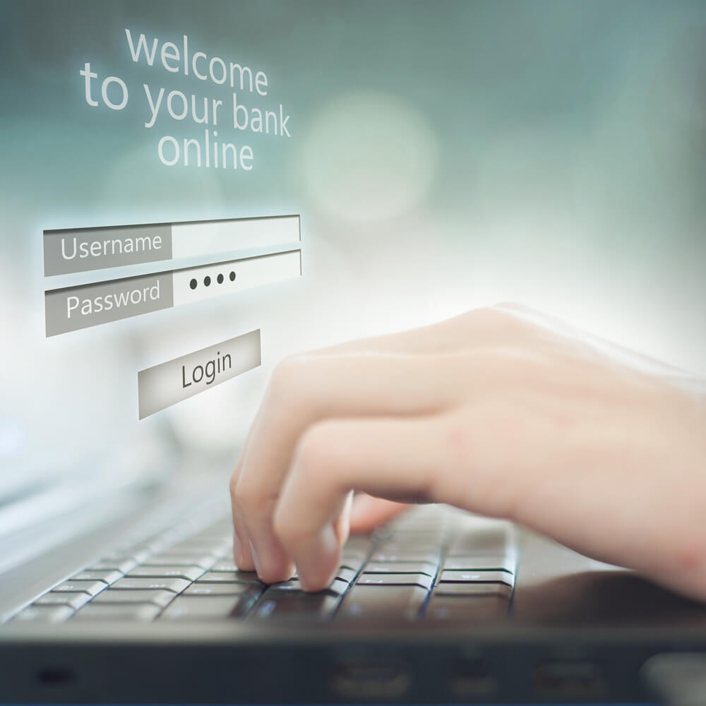 Illustration of hands on keyboard accessing their bank online banking.