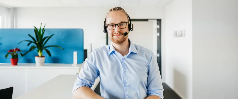 Man answering a call at an outbound call center service company.