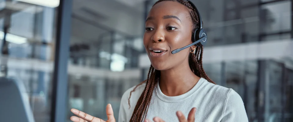 Woman at an outbound call center on the phone with a client.