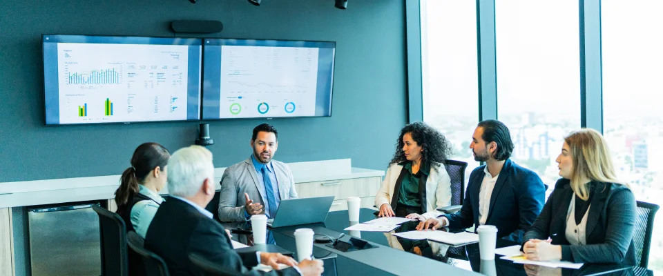 Businesspeople in a meeting discussing metrics of having a call center for financial services.