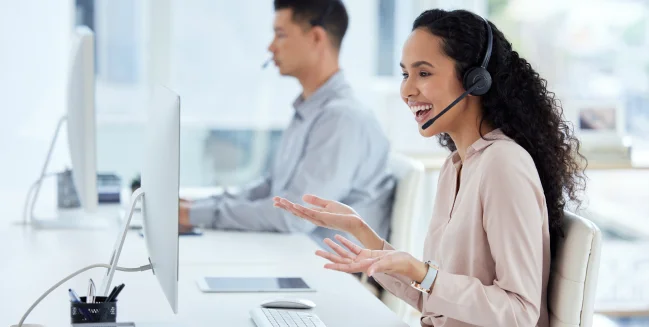 Call center, computer and consultant woman laughing in telemarketing office for online assistance or help.