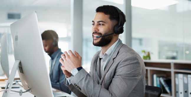 Computer, call center and happy man talking, crm and support at help desk office.